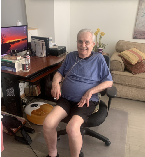 Man in blue shirt sitting at home